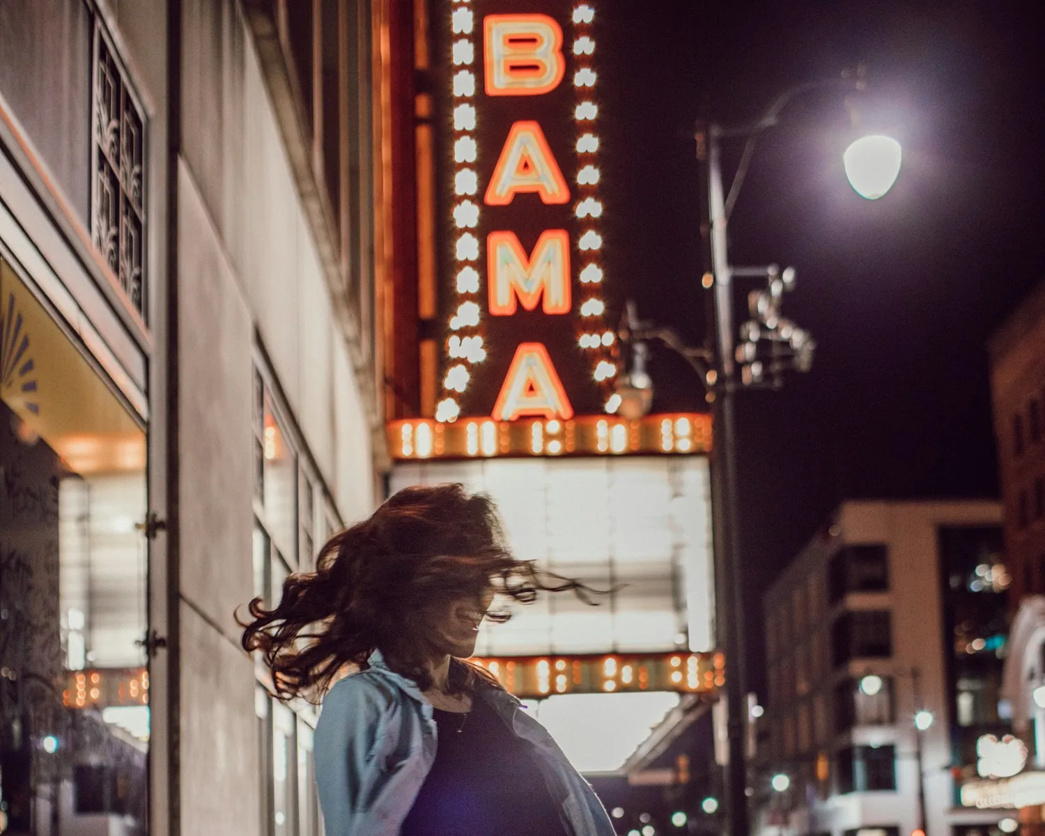 living in alabama woman shaking her head near post lamp